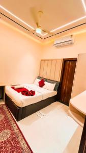 um quarto com uma cama com um cobertor vermelho em The Vacation Villa em Agra