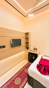 a bedroom with a bed and a flat screen tv at The Vacation Villa in Agra