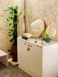 a dressing table with a mirror and books at Mika Homestay Simple & Cozy in Hanoi