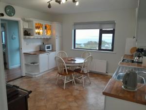 a kitchen and dining room with a table and chairs at Grandma's Cottage in Greencastle