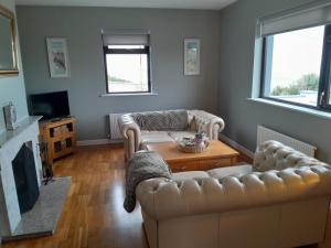 a living room with two couches and a table at Grandma's Cottage in Greencastle