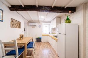 a kitchen with a table and a refrigerator at Da Antonio in Biassa