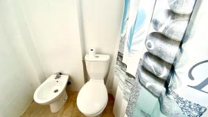 a small bathroom with a toilet and a sink at Island Village Sunset by Deihu Experiences in Adeje +29 photos