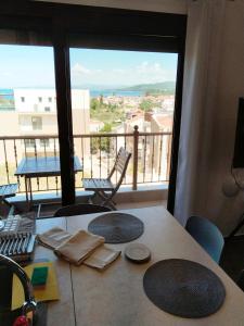 a room with a table and a view of a balcony at Theasis 2 in Neos Marmaras