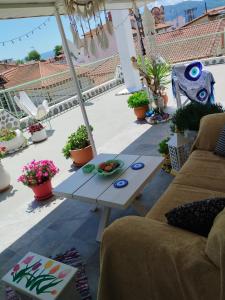 a patio with a couch and a table on a roof at Suzy's nest room in Asprovalta +43 photos