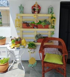 a patio with a table and chairs and plants at Suzy's nest room in Asprovalta