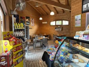 a restaurant with a counter and a table with food at Comfortable campsite-chalet G12 Tuscany at sea in Viareggio