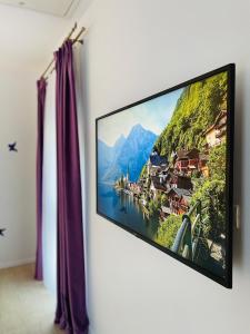 a flat screen tv hanging on a wall at S & S Apartment 2 bedroom with Balcony & Terrace Dumbravita free Parking at location 2 spaces in Dumbrăviţa +39 photos