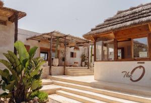 a house with stairs leading to a building at The O Experience - Tayourt Lodge in Imsouane