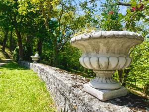 a large concrete vase sitting on a stone wall at Casa Barattini in Zocchetta