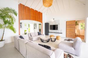 a living room with two couches and a table at Villa 0.5 in Saint-François
