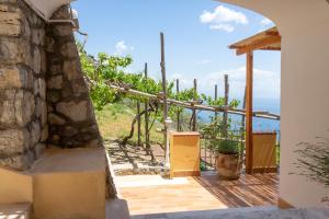 a room with a view of the ocean from a house at Tenuta La Picola in Furore