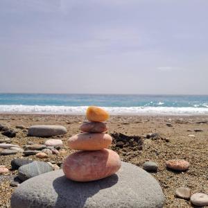 a stack of rocks sitting on a beach at Casa Michela in Letojanni