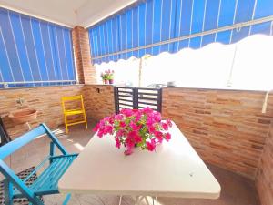 a white table with flowers on top of it at Casa Michela in Letojanni