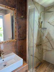 a bathroom with a sink and a shower at Hotel Royal Saranda in Sarandë