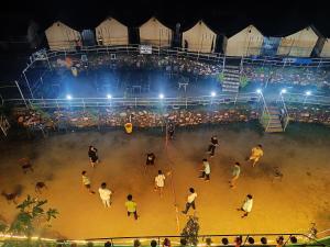 a group of people playing a game of basketball in an arena at Marine Drive Retreat in Rishīkesh