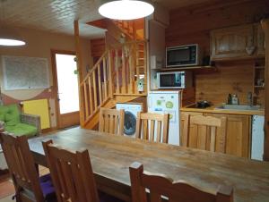 a kitchen and dining room with a table and chairs at Noyers du Soleil, Chambre d'hôte avec petit déjeuner à proximité de Gap in La Bâtie-Vieille