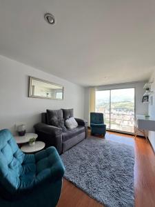 a living room with a couch and a table at Apto completo Atures la mejor vista y ubicación! in Pasto