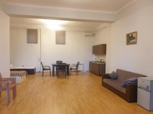 a living room with a couch and a table and chairs at Meri Residence Buzovna in Buzovna