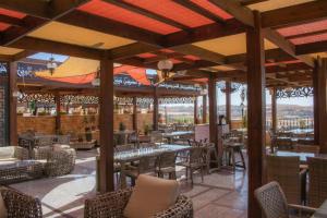 a restaurant with tables and chairs on a patio at Opal Hotel Amman in Amman
