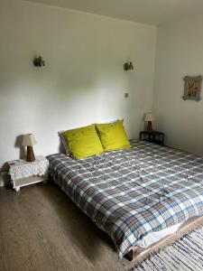 um quarto com uma cama grande e almofadas amarelas em Le Gast, Vaumeilh em Sisteron
