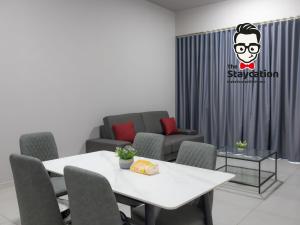 a room with a table and chairs and a couch at Staycation Homestay 32 The Echelon near Saradise in Kuching +18 photos