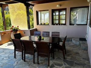 a dining room table and chairs in a patio at Elis superb villa in Ierápetra