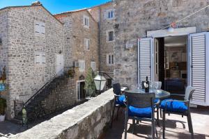 a patio with a table and chairs in front of a building at Apartment Lucky in Budva