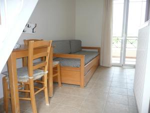 a small room with a bed and a table and chairs at Elia Apartments in Oreoi