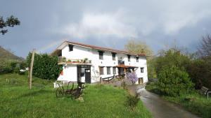 a white house on the side of a road at Balentziaga in Azcoitia