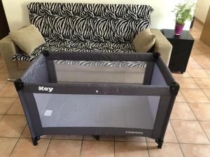 a large tv box sitting in front of a couch at Vacanza a Miglieglia in Miglieglia