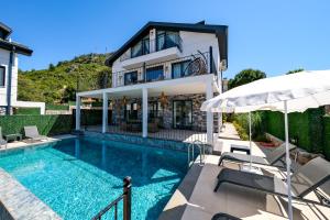 a villa with a swimming pool and a house at Oasis Family-Friendly Luxury Villa Fethiye Oludeniz by Sunworld Villas in Fethiye