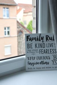 a window sill with a sign in a window at Cozy Studio in the city center in Klaipėda