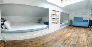 1 dormitorio con 1 cama en una habitación con suelo de madera en Buky Palace, en Pons