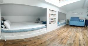 a bedroom with a bed in a room with a wooden floor at Buky Palace in Pons +56 photos