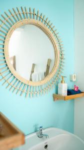 a mirror above a sink in a bathroom at The White Bay Lombok in Kuta Lombok +48 photos