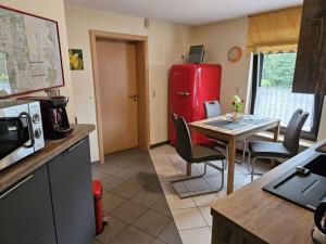 a kitchen with a table and a red refrigerator at Vakantieappartement Eldeufer II in Plau am See +33 photos