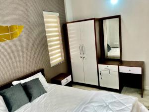 a bedroom with a bed and a large mirror at Appartment in Ernakulam