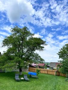 a picnic table and chairs in a yard with a tree at Eduard Inn in Vulcan