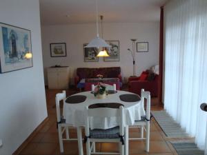 a living room with a table and a couch at Nice holiday home near town centre in Juist