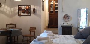 a bedroom with a bed and a table and chairs at Ancient Medieval Chapel in Amalfi