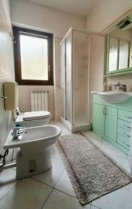 a bathroom with a toilet and a sink at Holiday Home with lovely garden, Tremezzina in Lenno