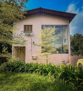 a house with a window and a tree at SecretTuscanGarden-3BHK luxury Italian Villa in Auroville +16 photos