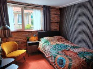Postel nebo postele na pokoji v ubytování Hotel Dichtbijzee