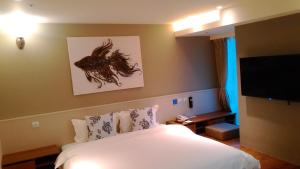 Letto o letti in una camera di Walker Hotel. Ximen