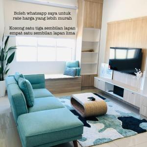 a living room with a couch and a tv at Maryam’s House (Lovely Seaview apartment ) in Kuala Terengganu +9 photos