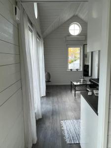 a living room with white walls and a window at White little house on the countryside, close to Stockholm in Vidja