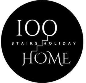 a black circle with the words states holiday home at 100 stairs holiday home in Mussoorie