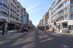 an empty street in a city with tall buildings at Studio Belle Vue in Koksijde