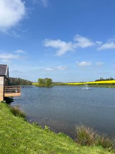 a view of a lake with a wooden dock at East Learmouth Lakeside Lodges in Cornhill-on-tweed